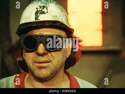 Man wearing hard hat and protective glasses, portrait Stock Photo