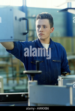 Man in coveralls in workshop Stock Photo