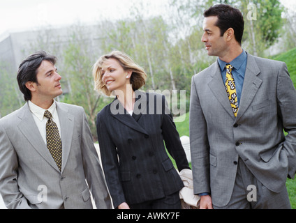Three business people walking outside,smiling Stock Photo