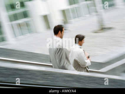 Two businessmen on stairs outside, blurred Stock Photo