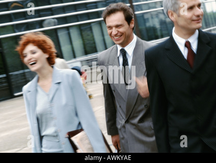 Three business people walking outside Stock Photo