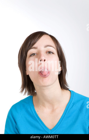 Woman sticks her tongue out Stock Photo - Alamy