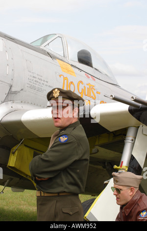 World War 2 re enactment member dressed up as Second World War  US American pilot standing in front of P 47 Thunderbolt aircraft Stock Photo