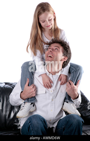 Daughter sitting on her father's shoulders Stock Photo