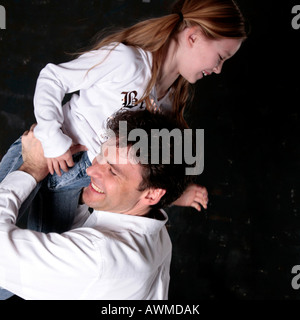 Father and daughter tussling Stock Photo