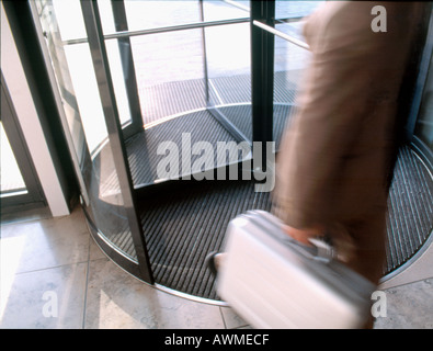 High angle view of businessman walking through revolving door Stock Photo