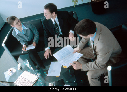 High angle view of businesswoman and two businessmen discussing in meeting Stock Photo