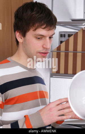 Young man concentrating on work at a desk Stock Photo