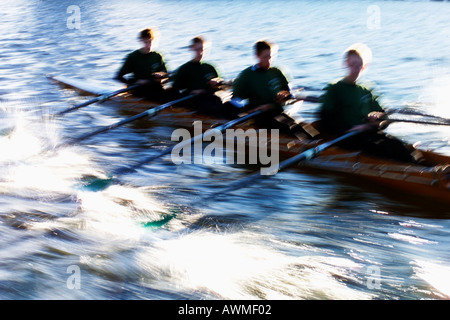 Four man in rowing boat blurred Stock Photo