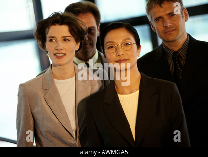 Four business people grouped together Stock Photo