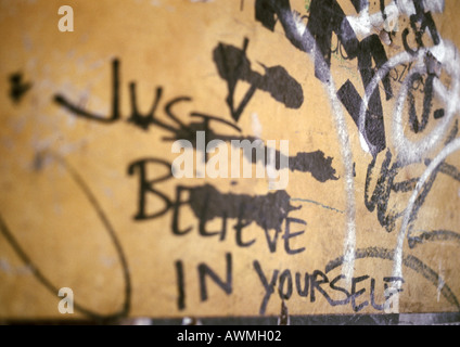Just believe in yourself written text and graffiti on wall, close-up Stock Photo