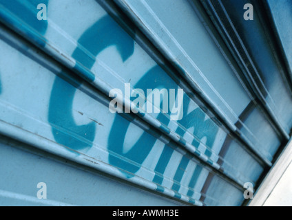 Com text painted on roller shutter, close-up Stock Photo