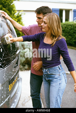 Man and woman washing car Stock Photo
