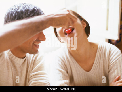 Man feeding woman, close-up Stock Photo