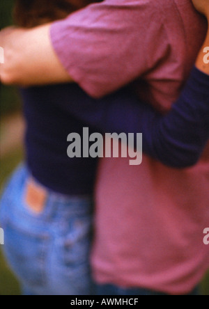 Two people hugging, mid-section, blurred Stock Photo