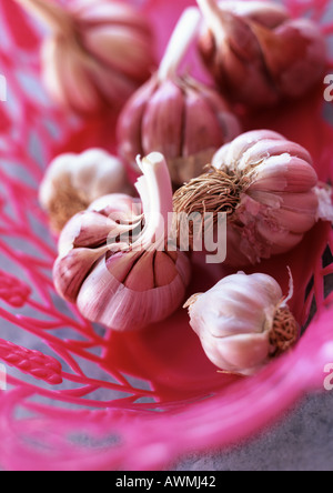Garlic bulbs in pink basket, close-up Stock Photo