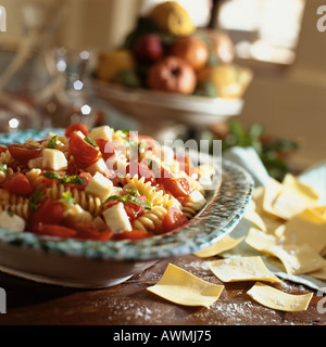 Fresh pasta salad with fusilli, cherry tomatoes, mozzarella cheese and basil Stock Photo
