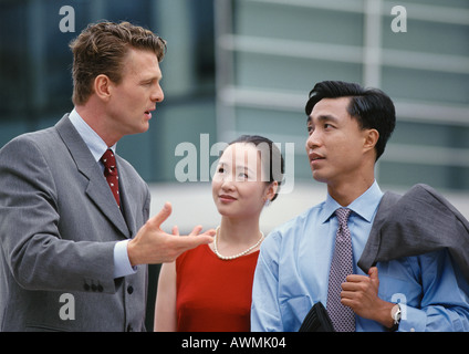 Business associates having discussion, one gesturing with hand Stock Photo