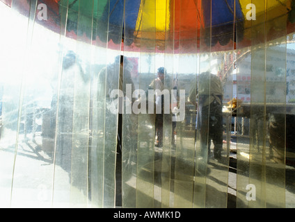 China, Xinjiang, Urumqi, plastic curtain, people wearing aprons, outside Stock Photo