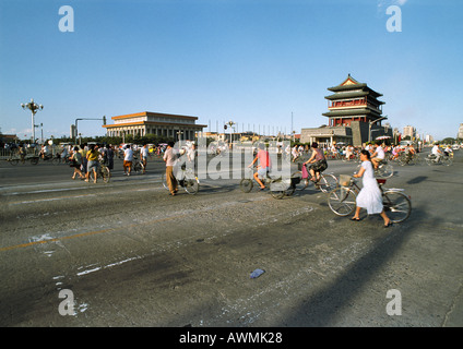 China, Beijing, Tiananmen Square, people with bikes crossing street Stock Photo