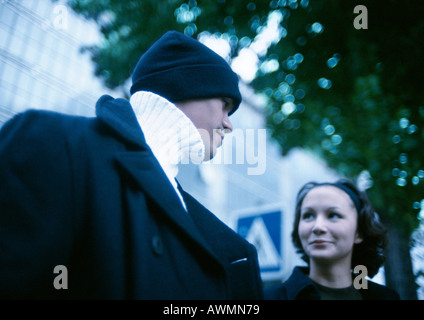 Young man and woman in street, low angle view Stock Photo