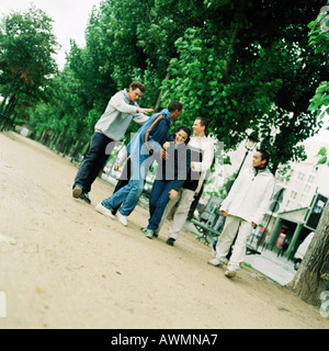 Group of young people walking in park Stock Photo