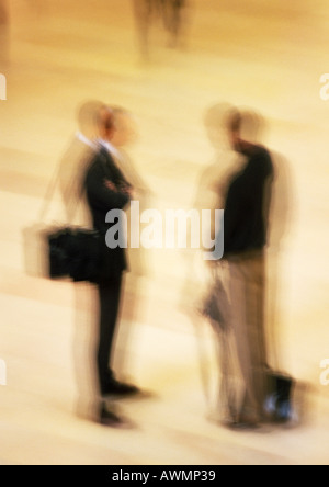 Two men standing in concourse, blurred Stock Photo