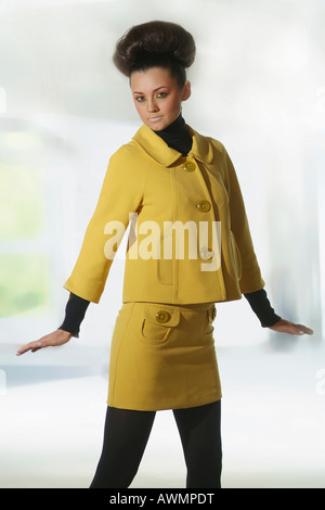Young woman wearing retro sixties outfit with her hair done in an updo (beehive) Stock Photo