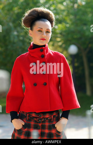 Young woman dressed in retro sixties outfit with her hair done in an updo (beehive) Stock Photo