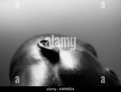 Side of man's head, low angle view, close up, black and white. Stock Photo