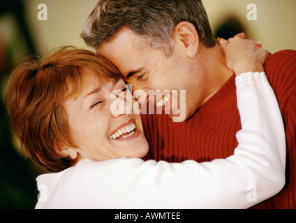 Man and woman hugging, smiling, close up Stock Photo
