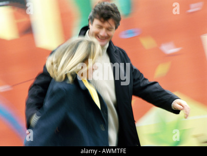 Man and woman walking together, man's arm around woman, blurred Stock Photo