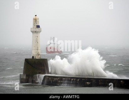 Oil supply vessel struggles to get into Aberdeen Harbour, Scotland, UK, during rough seas after a storm in winter Stock Photo