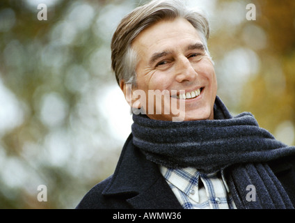 Man smiling, scarf around neck, head and shoulders, close up, portrait Stock Photo