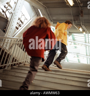 Young people walking up stairs in elevated subway station Stock Photo