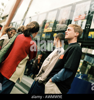 Group of young people standing in front of movie theater Stock Photo