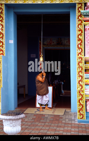 Savanne Region Mauritius Hindu Tamil Temple Priest Speaking on Mobile Phone Sri Siva Subarmaniya Kovil Stock Photo