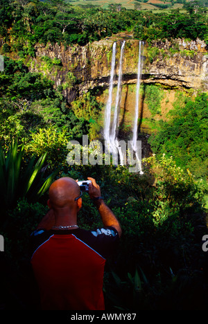 Chamarel Waterfall Mauritius Bald Headed Man taking Photograph with Digital Camera- falls formed by River St Denis and surrounded by Vegetation of Stock Photo