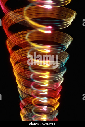 Spiraling light effect, one within the other, reds, yellows and hints of blues. Stock Photo