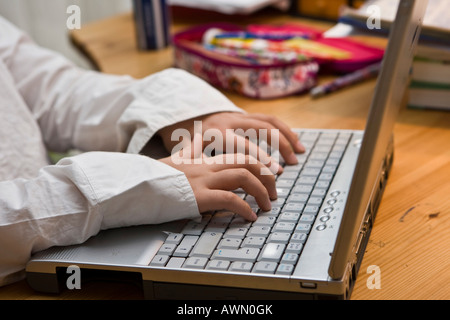 Young schoolgirl working with laptop Stock Photo