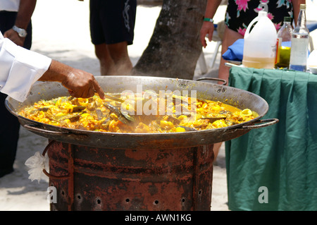 Cook preparing paella on the beach in Punta Cana, Dominican Republic, Caribbean, Americas Stock Photo