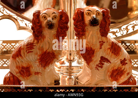 Two Cocker Spaniel porcelain figurines sitting on silver platter Stock Photo