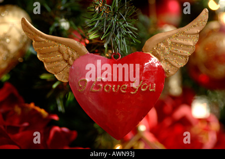Heart with wings, Christmas ornament hanging in Christmas tree Stock Photo
