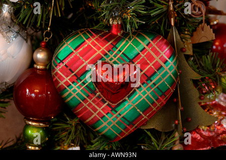 Heart-shaped Scottish tartan Christmas ornament hanging in Christmas tree Stock Photo