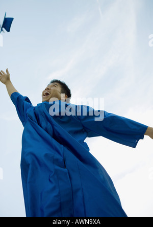 Male graduate throwing cap Stock Photo