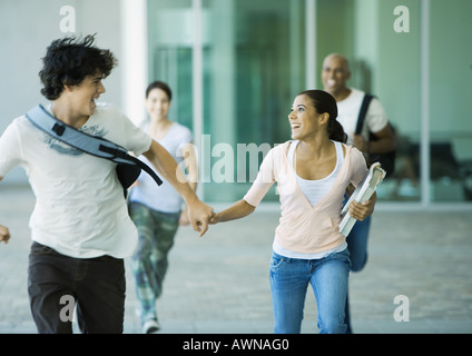 Students running across campus Stock Photo