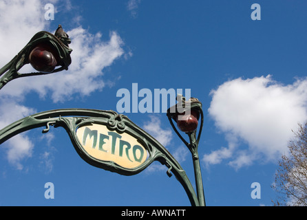 France Paris Metro station close up of traditional metro sign at station entrance with blue sky and light clouds in bkgd Stock Photo