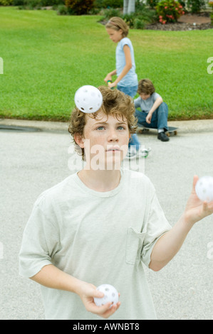 Boy juggling Stock Photo