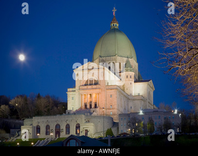 Saint Joseph's Oratory on Mount Royal in the evening with the full moon rising in Montreal Quebec, Canada. Stock Photo