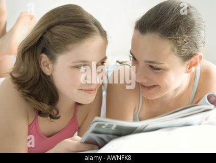 Preteen girls reading magazine together Stock Photo